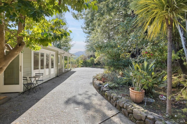 view of yard featuring a mountain view and a patio