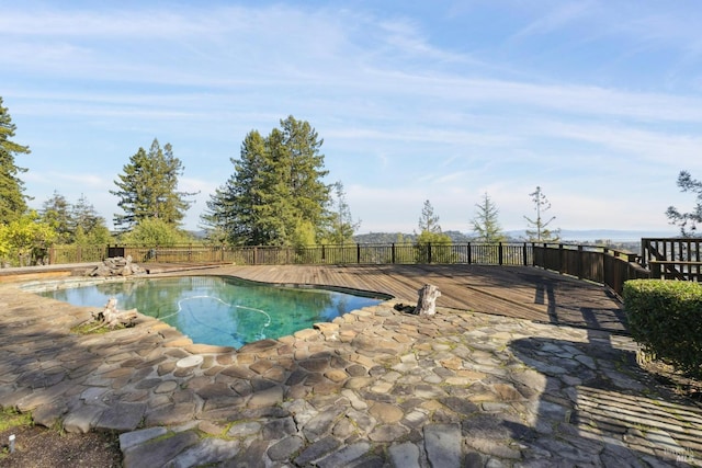 view of pool featuring a patio and a deck