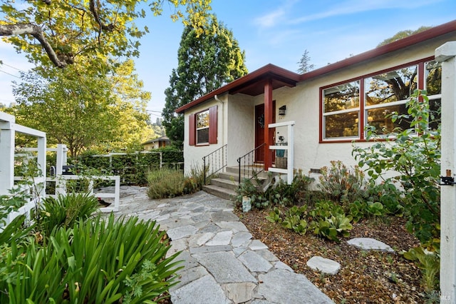 exterior space featuring fence and stucco siding