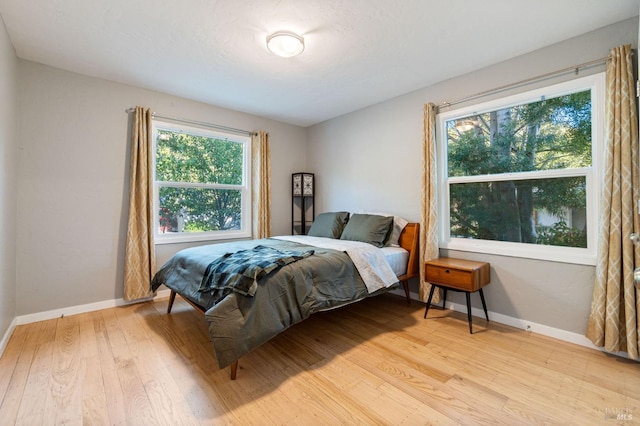 bedroom with baseboards and light wood-style floors