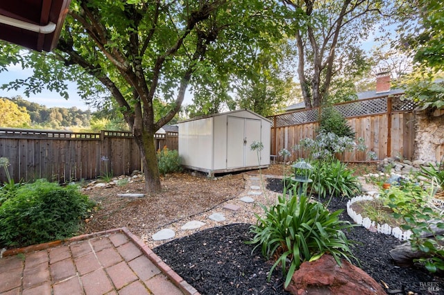 view of yard with a storage shed, an outbuilding, and a fenced backyard