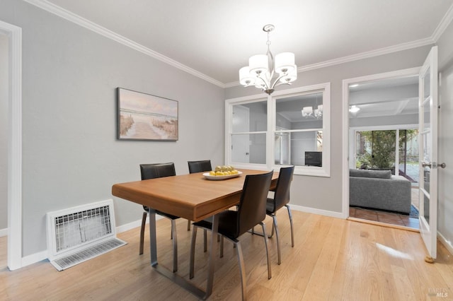 dining space with crown molding, a notable chandelier, baseboards, and light wood-type flooring