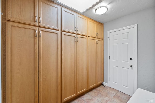 mudroom with light tile patterned floors