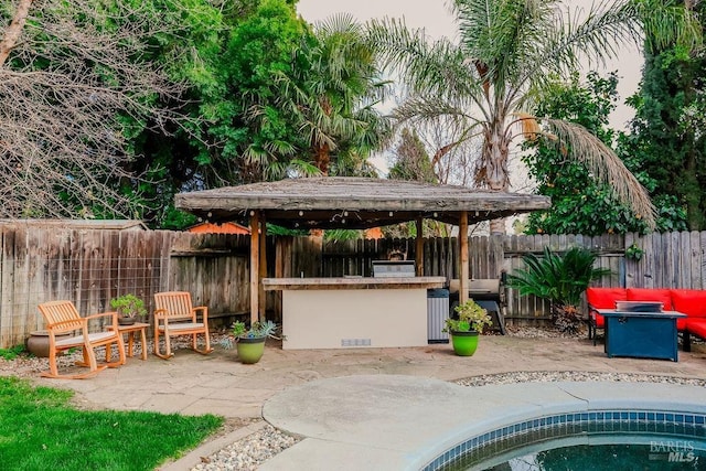 view of patio featuring a fenced backyard and outdoor dry bar