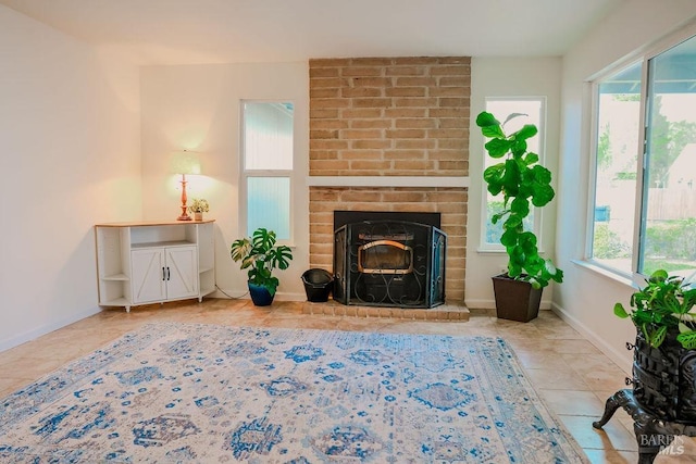 living area with tile patterned flooring, a fireplace, and baseboards