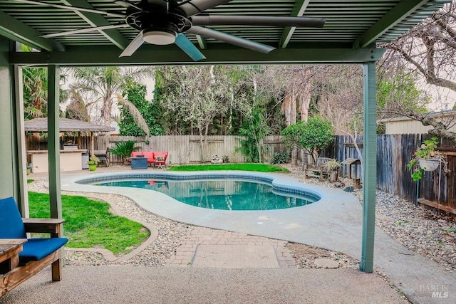 view of swimming pool with a fenced backyard, ceiling fan, a fenced in pool, and a patio