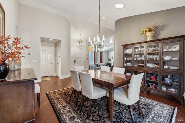 dining room featuring an inviting chandelier and dark hardwood / wood-style floors