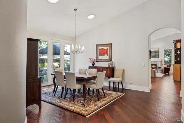 dining room featuring an inviting chandelier, dark hardwood / wood-style floors, and high vaulted ceiling