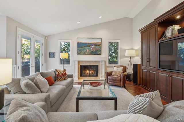 living room with french doors, vaulted ceiling, and hardwood / wood-style floors