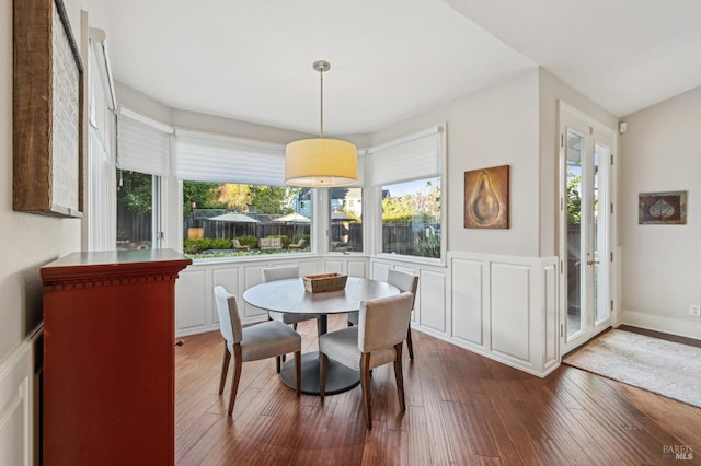 dining space with wood-type flooring