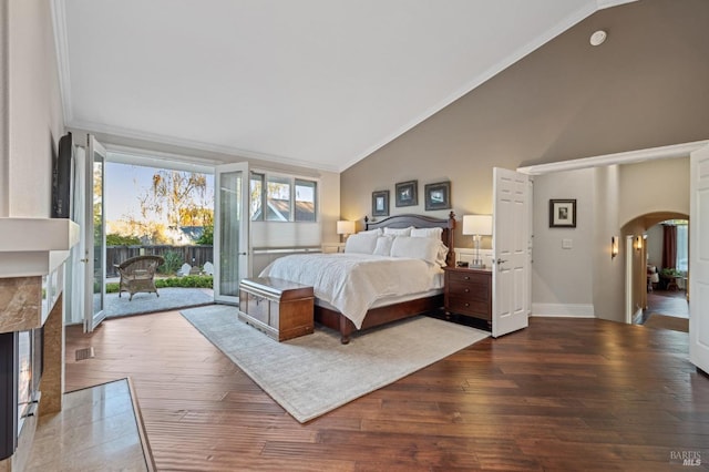 bedroom featuring a premium fireplace, ornamental molding, access to exterior, and dark hardwood / wood-style flooring