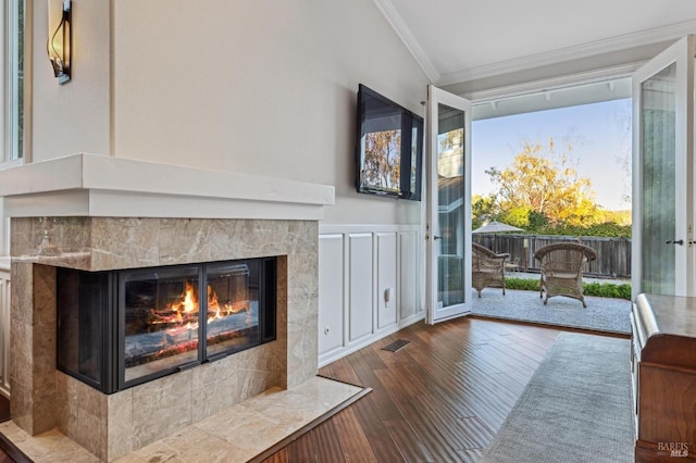 interior space featuring a fireplace, ornamental molding, and wood-type flooring