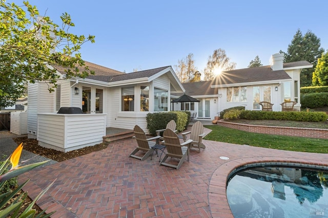 rear view of property featuring a patio