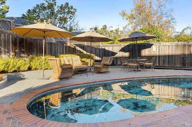 view of swimming pool featuring an outdoor living space and a patio area