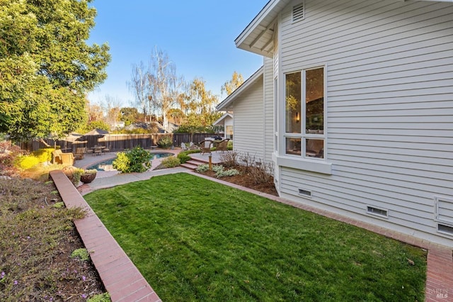 view of yard featuring a fenced in pool and a patio area