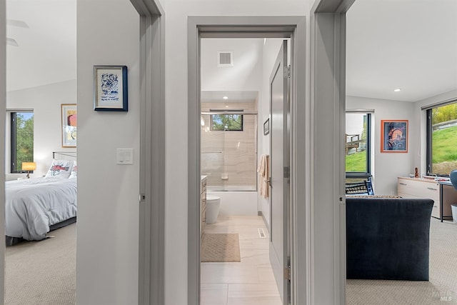 corridor featuring light colored carpet