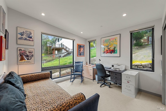 carpeted home office featuring vaulted ceiling