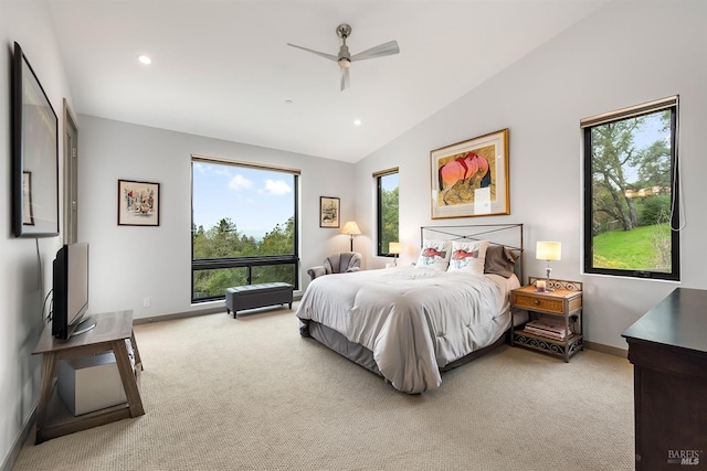 carpeted bedroom with ceiling fan and vaulted ceiling