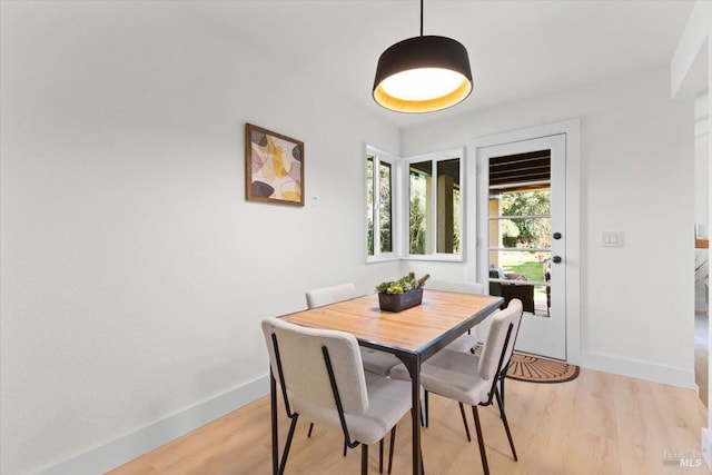 dining space with light hardwood / wood-style floors