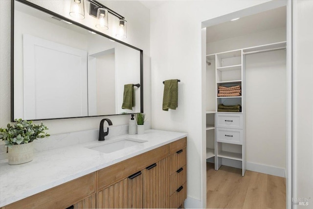 bathroom with vanity and wood-type flooring