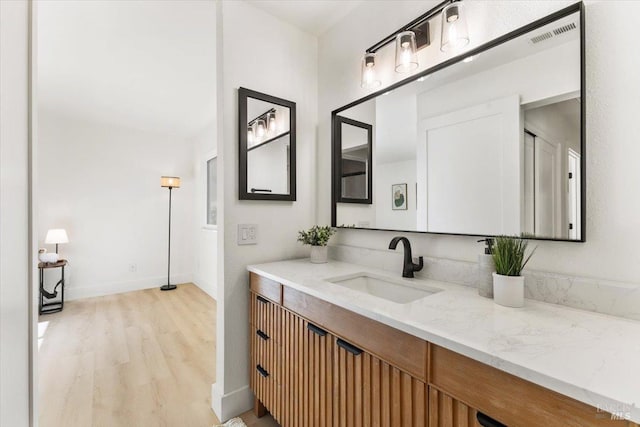 bathroom featuring hardwood / wood-style flooring and vanity