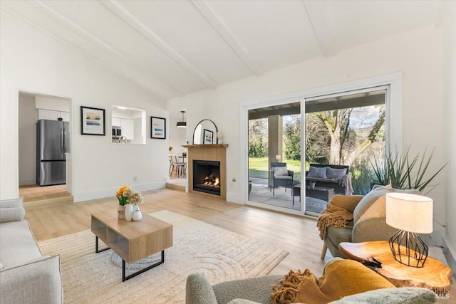 living room with beam ceiling, light hardwood / wood-style flooring, and high vaulted ceiling