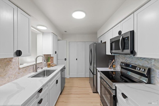 kitchen featuring light stone counters, white cabinets, and appliances with stainless steel finishes