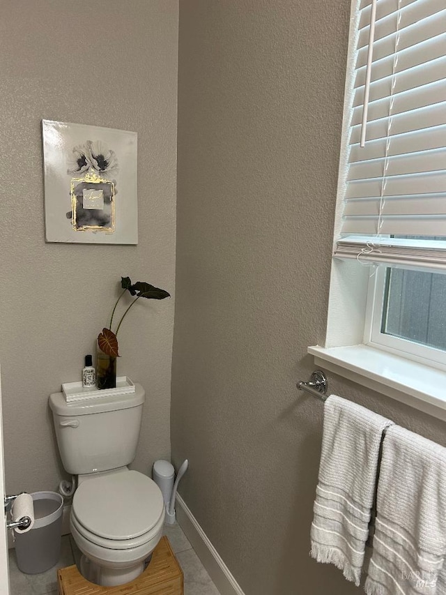 bathroom featuring tile patterned flooring and toilet