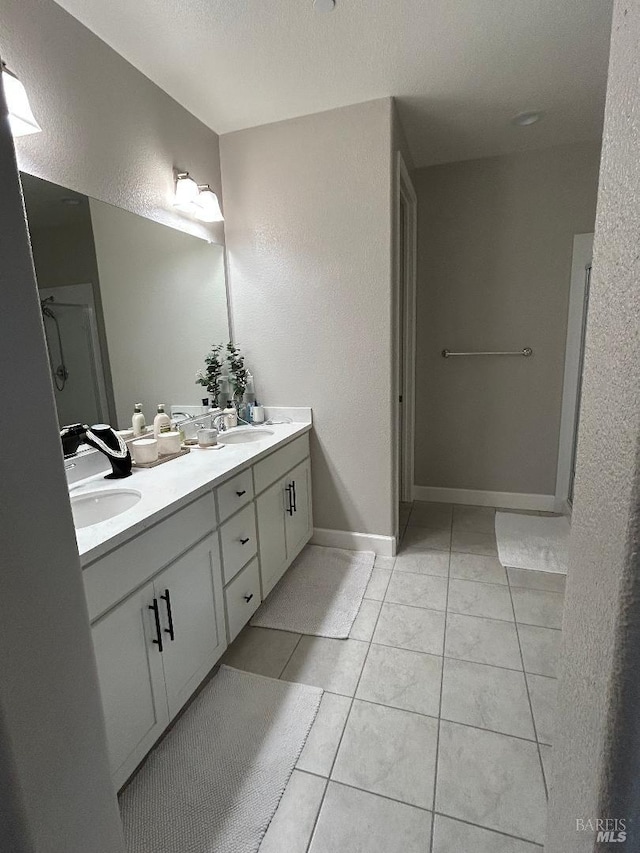 bathroom featuring tile patterned flooring and vanity