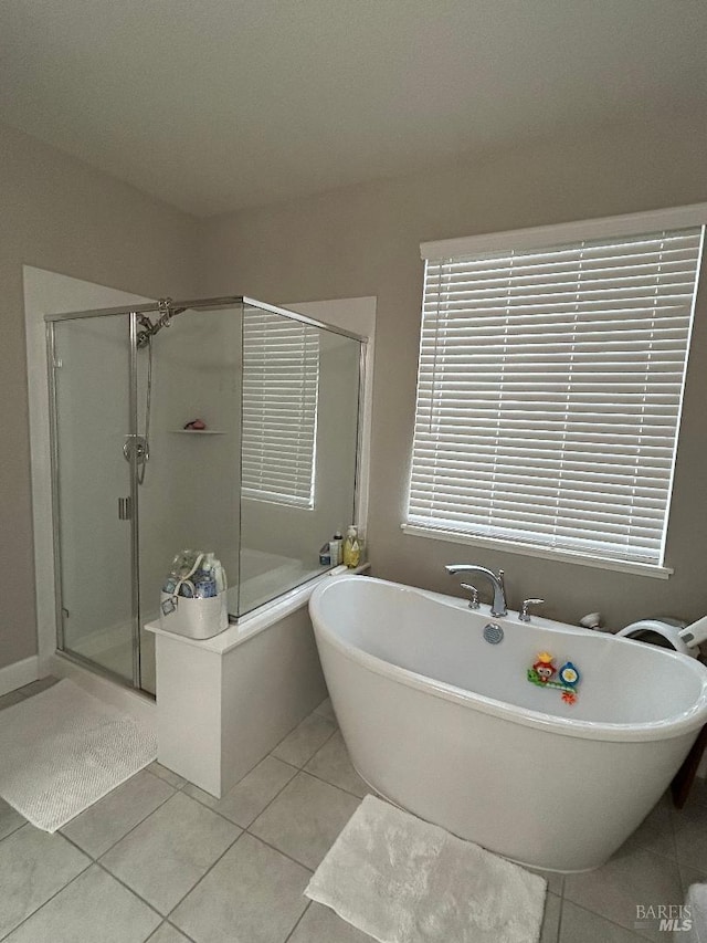 bathroom featuring plus walk in shower and tile patterned floors