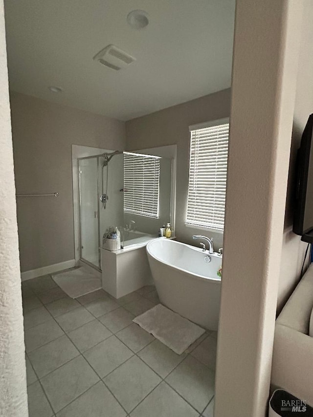 bathroom featuring tile patterned floors and shower with separate bathtub