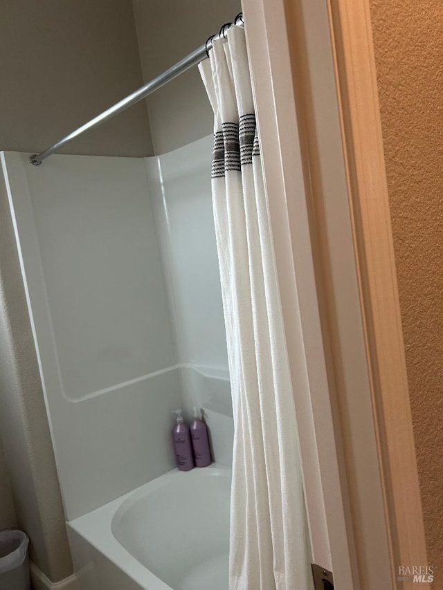 bathroom with shower / bathtub combination with curtain