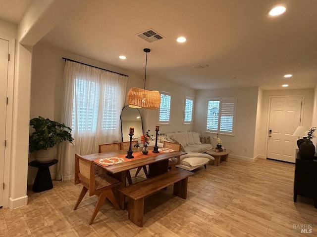 dining space with light hardwood / wood-style flooring