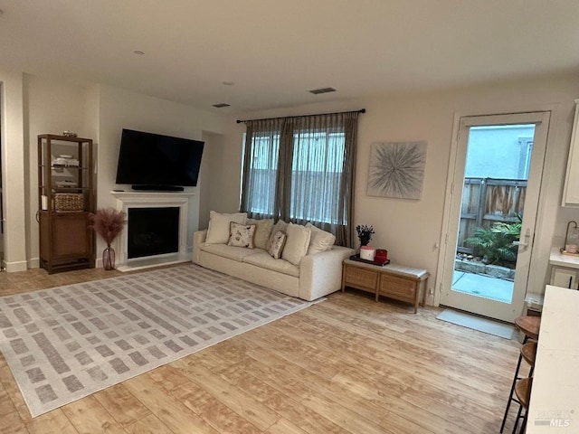 unfurnished living room with light hardwood / wood-style flooring and plenty of natural light