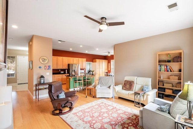 living area with light wood finished floors, visible vents, recessed lighting, and a ceiling fan