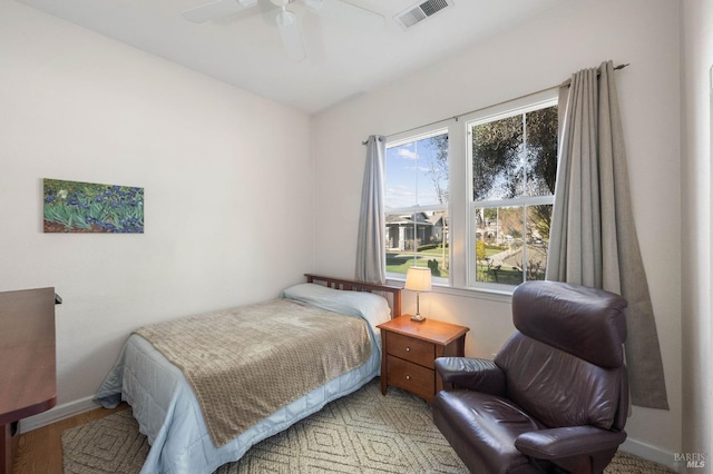 bedroom featuring visible vents, a ceiling fan, and baseboards