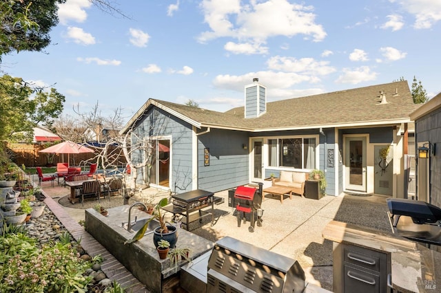 back of house with a patio area, a chimney, outdoor lounge area, and roof with shingles