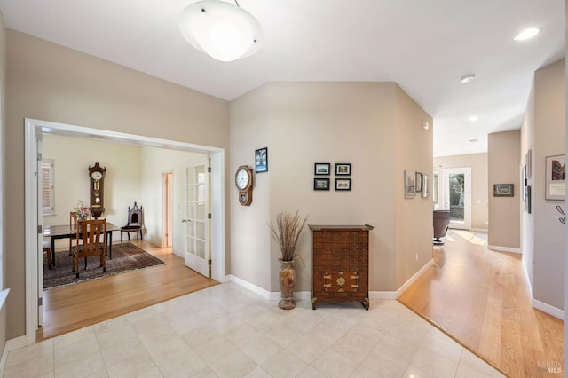 entryway featuring light wood finished floors, recessed lighting, and baseboards