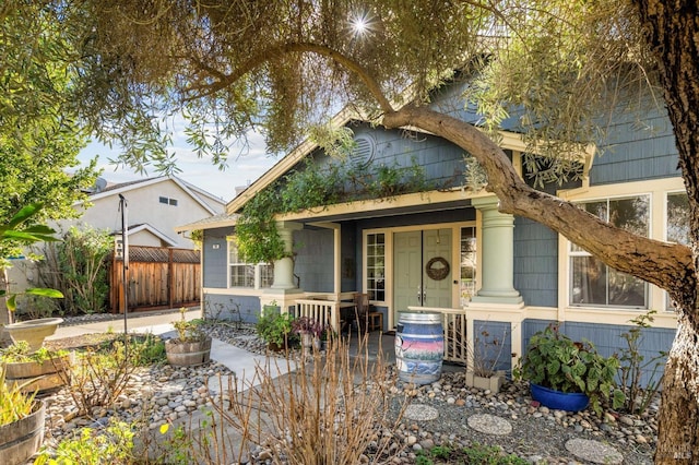 view of front of home featuring fence and covered porch