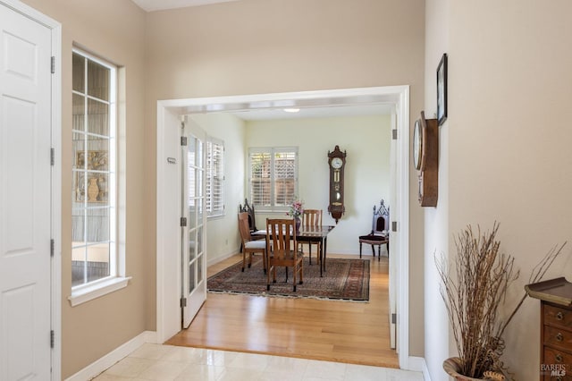 dining space featuring light tile patterned floors and baseboards