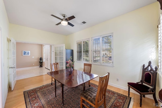 dining space featuring visible vents, baseboards, and light wood-style flooring