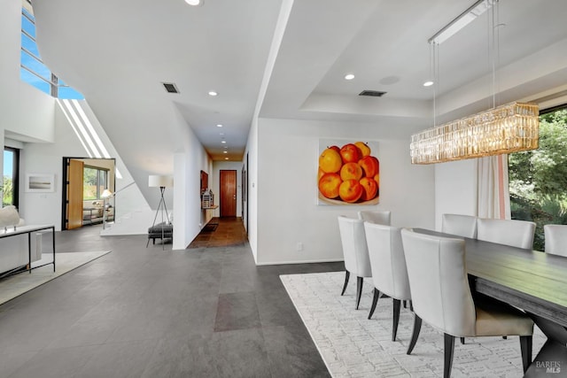 dining space featuring a chandelier, visible vents, and plenty of natural light