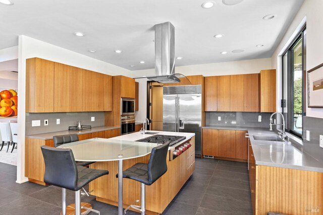 kitchen featuring built in appliances, sink, a spacious island, and island exhaust hood