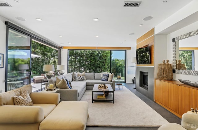 living room with expansive windows and a large fireplace