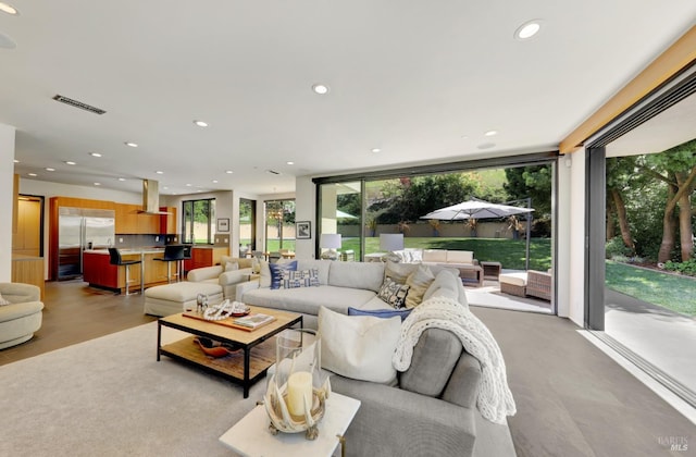 living room featuring recessed lighting and visible vents