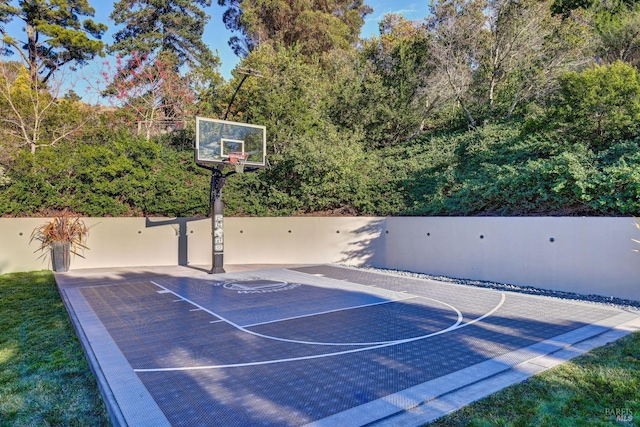 view of sport court with basketball court and fence