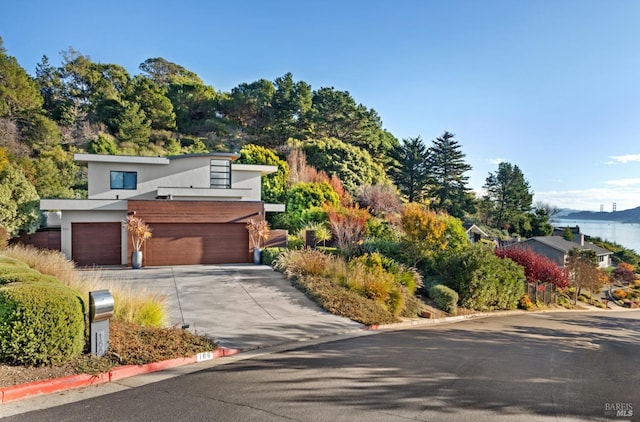 contemporary house featuring a water view and a garage