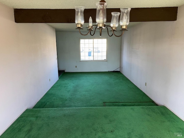 carpeted spare room featuring an inviting chandelier