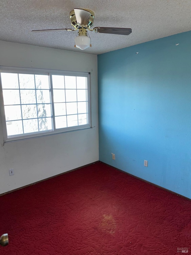 unfurnished room with ceiling fan, a healthy amount of sunlight, carpet flooring, and a textured ceiling