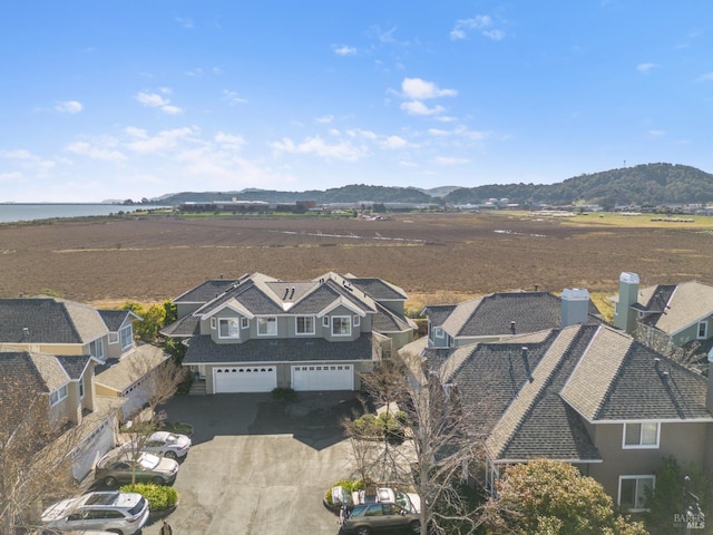 bird's eye view with a water and mountain view